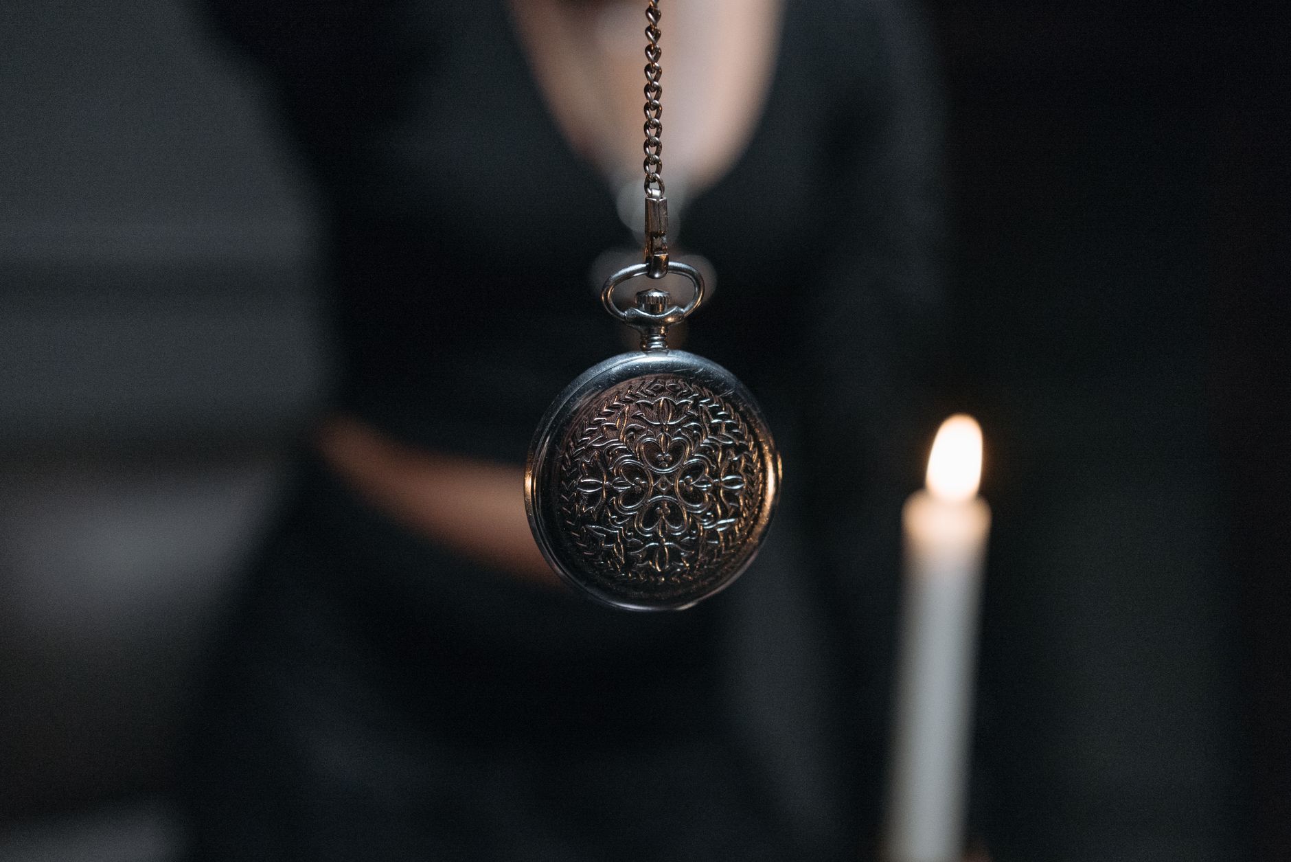 close up shot of a silver round pendant